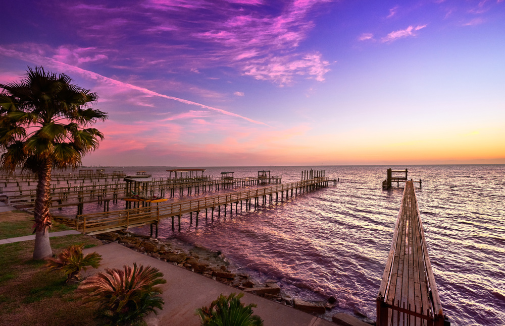 Fiery colors in the sky at first light, Galveston Bay, Texas